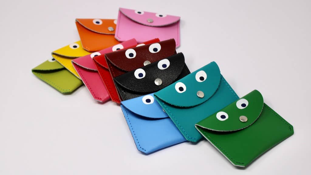 Colorful small envelopes with googly eyes on a white background